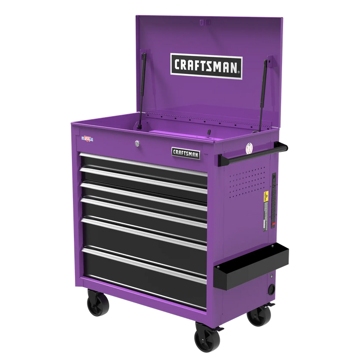 A purple Craftsman rolling tool chest with an open top compartment, five drawers, and side handles. The chest is on four black caster wheels and has a side tray attached.
