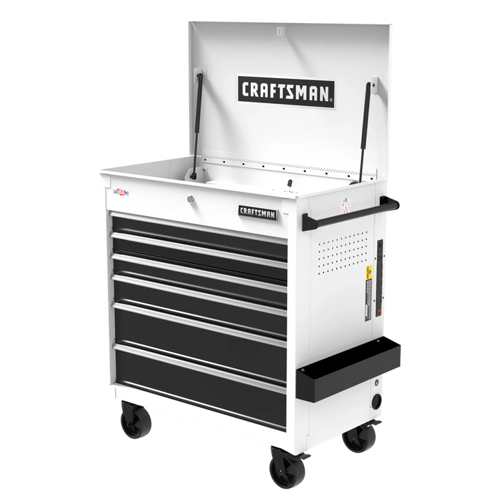A white and black rolling tool chest with six drawers and a hinged top compartment, branded with 'CRAFTSMAN' on the front and inside the lid. The tool chest has wheels for mobility, a side handle, and side tray for extra storage.