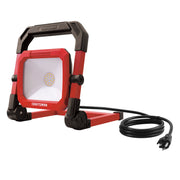 Photo of Craftsman portable LED work light CMXELAYMPL1026, red and black, angled view, with power cord.