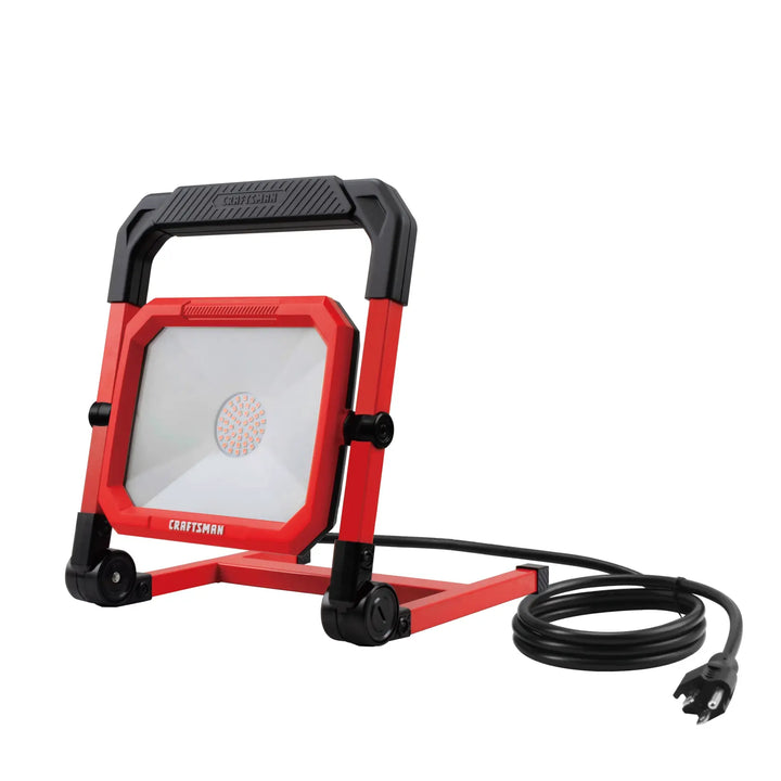 Photo of Craftsman LED work light CMXELAYMPL1027, red frame, handle, coiled cord, front angle.