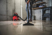 Photo of Craftsman wet/dry vacuum CMXEVBE17584 cleaning water from a basement floor, person using floor nozzle.