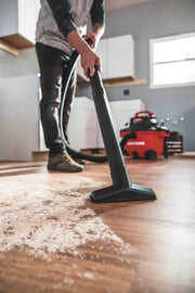 Photo of CRAFTSMAN wet/dry vacuum CMXEVBE17594 cleaning debris from a hardwood floor in a home setting.