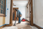Photo of Craftsman wet/dry vacuum CMXEVBE17594 used by a worker cleaning a wood floor during renovation.