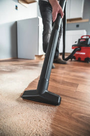Photo of Craftsman wet/dry vacuum CMXEVBE17594 cleaning sawdust on wood floor, vacuum in use, red unit visible.