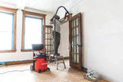 Photo of CRAFTSMAN wet/dry vacuum, SKU CMXEVBE17656, cleaning dust near a ceiling in a bright room with wood trim.