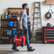 Photo of Craftsman wet/dry vacuum CMXEVBE18690 being carried in a garage workshop setting.
