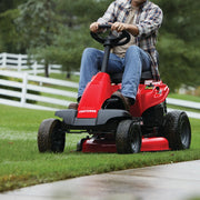 Photo of Craftsman riding lawn mower, SKU CMXGRAM1130035, red, front side view cutting grass outdoors.
