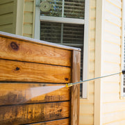 Photo of Craftsman CMXGWFN061255 pressure washer cleaning a wooden fence, water spray visible.