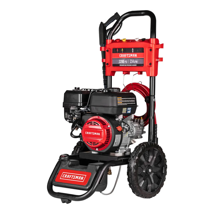 A Craftsman branded gas-powered pressure washer with a red and black color scheme, large wheels for portability, and a handle at the top. The unit displays specifications of 3200 PSI and 2.4 GPM. The pressure washer has various attachments and hoses arranged on the frame.