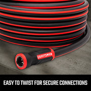 Photo of Craftsman black and red garden hose CMXMHBB16513 with easy-twist connector, coiled on concrete.