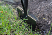 Photo of CRAFTSMAN lawn edger blade CMXMLTP35324 in use, cutting between grass and soil.