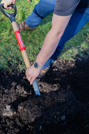 Photo of Craftsman shovel CMXMLTP35327 in use, digging soil in a garden.