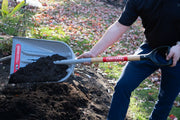 Photo of Craftsman shovel CMXMLTP35332 with wood handle scooping soil outdoors.