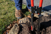 Photo of CRAFTSMAN post hole digger CMXMLTP35333 in use, digging soil near rocks outdoors.