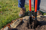 Photo of CRAFTSMAN post hole digger CMXMLTP35333 with red handles used in soil near rocks.