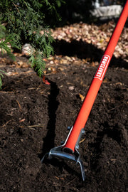 Photo of CRAFTSMAN garden cultivator, SKU CMXMLTP35334, with red handle and metal tines in soil.