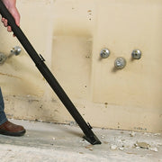 Photo of CRAFTSMAN CMXZVBE38675 vacuum wand attachment in use on construction debris, close-up side angle.
