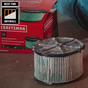 Photo of Craftsman drywall air filter CMXZVBE38740, cylindrical with pleated green filter, shown used beside box.