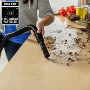 Craftsman vacuum hose CMXZVBE38740 cleaning fine indoor particles from a tabletop in a workshop setting.