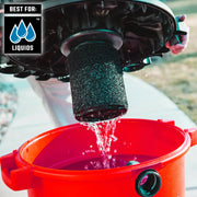 Craftsman wet vacuum filter CMXZVBE38778 draining liquid into a red bucket outdoors, close-up photo.
