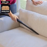 Photo of CRAFTSMAN upholstery vacuum attachment CMXZVBE38786 cleaning a beige couch cushion.