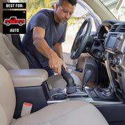 Craftsman auto vacuum brush attachment CMXZVBE38803 in use cleaning car interior center console, close-up view.