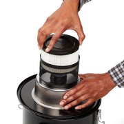 Photo of Craftsman vacuum filter CMXZVBE43268 being installed in a black metal vacuum, overhead angle.
