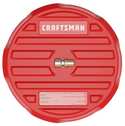 A red circular plastic product labeled 'Craftsman', featuring a brass fitting in the center and warning text at the bottom. The item appears to be a photography accessory or tool, possibly a protective cover or lid.